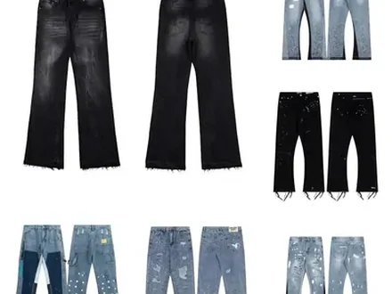 Seven pairs of jeans laid flat, washed black through to faded blue