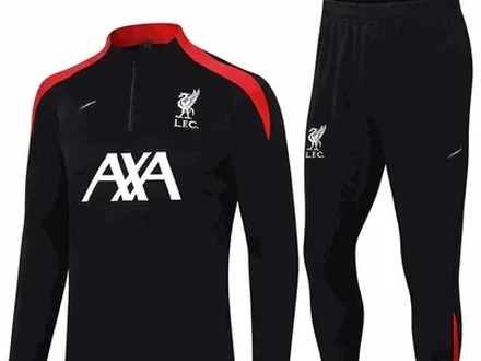 A black football training top with a sponsor across the chest, shown with matching trousers