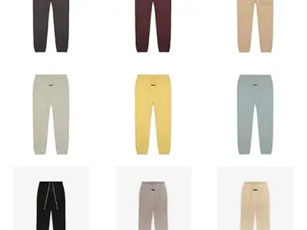 Nine pairs of plain sweatpants in muted colours, three rows of three