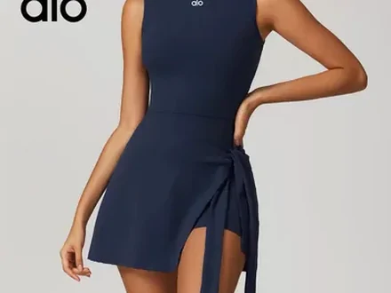 A navy wrap mini dress worn by a model, photographed from the shoulders down